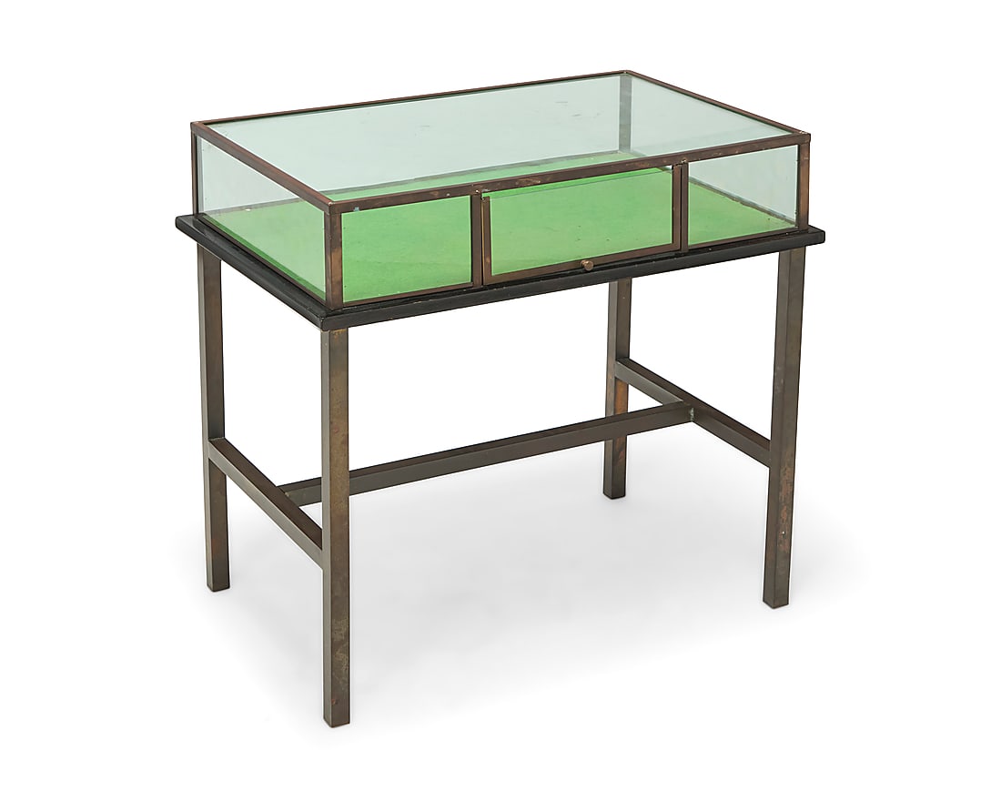 An industrial style metal vitrine table: An industrial style metal vitrine table Late 20th century Glass etched: NV Hardglas Zoetermeer With glazed case and hinged front door, velvet-lined wood display surface, and metal frame base Overall