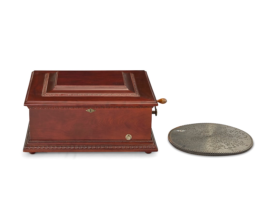 A Symphonion mahogany music box: A Symphonion mahogany music box 20th century, with later elements Impressed to inner plate: 11853; numbered to paper label: Symphonion no. 43 / Requires Disc no. 143; with applied plaque: FROM THE SOU