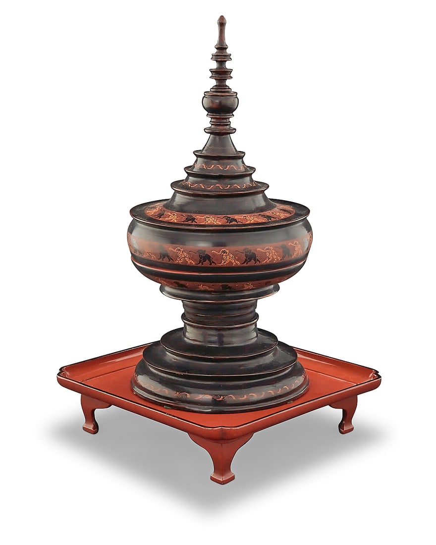 A Southeast Asian lacquered wood offerings vessel: A Southeast Asian lacquered wood offerings vessel 19th/20th century or later Depicting red on black elephants, comprising a turned lid, inner tray, and tiered base, raised on a possibly associated ora