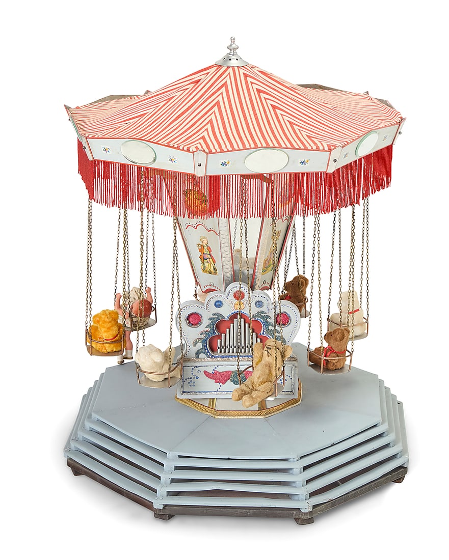 A Folk art wood and tole tabletop carousel: A Folk art wood and tole tabletop carousel Early/mid-20th century, probably Joseph Miller Wiener Prater model Unmarked Painted metal mounted with printed paper figures, the rotating top fitted with me