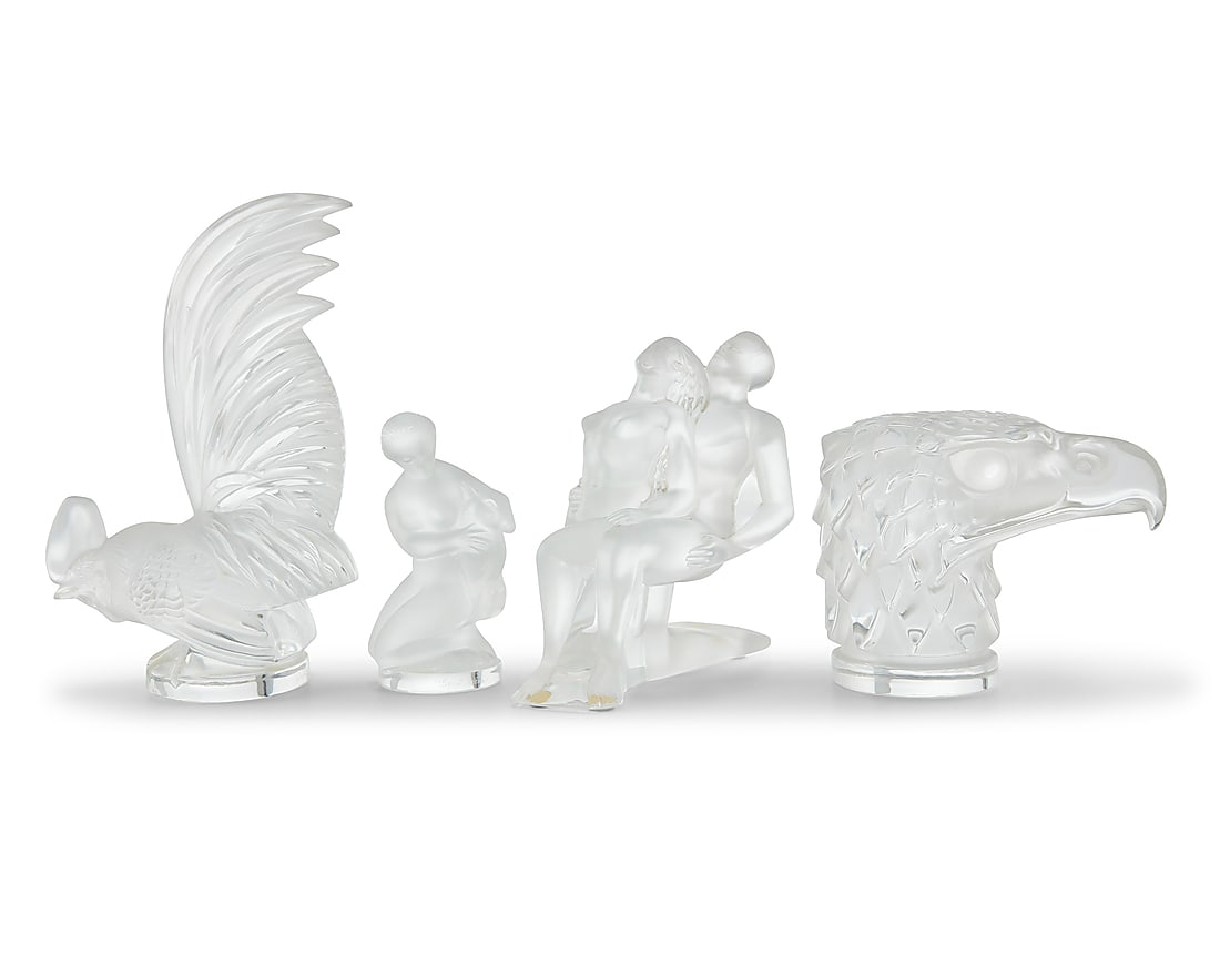 Four Lalique glass articles: Four Lalique glass articles Late 20th/early 21st century Each etched: Lalique ® France Comprising a 'Coq Nain' rooster, 'Tete D'Aigle' eagle head, 'Danseurs Enlaces' figural group, and another