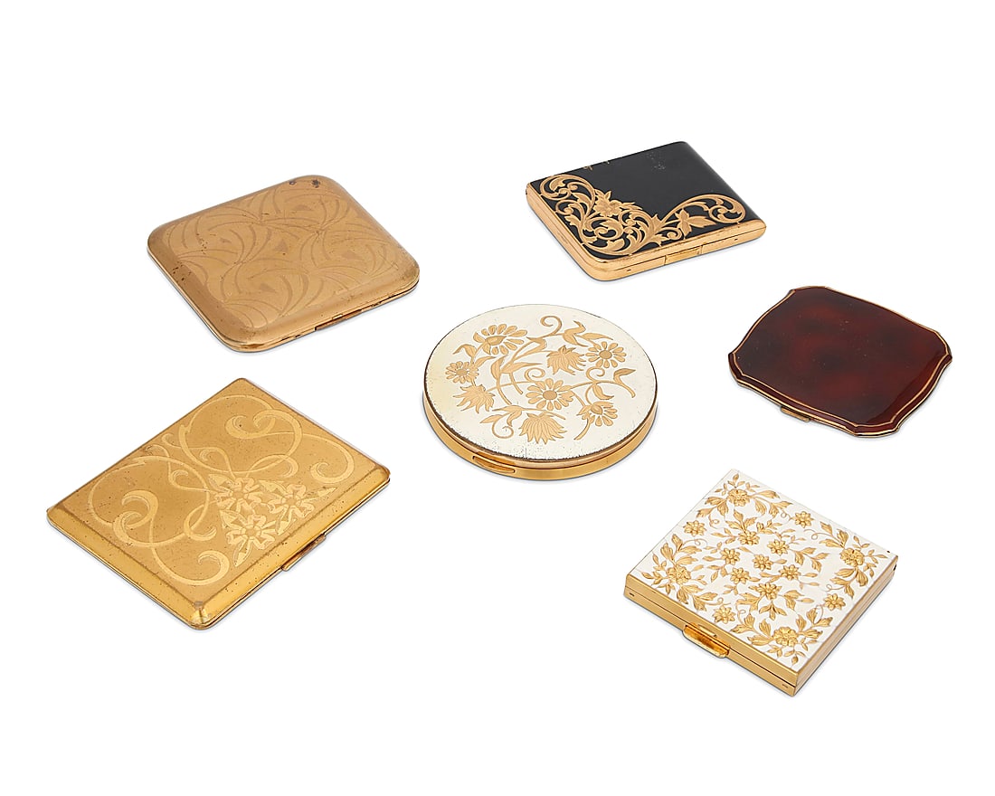 A group of six compacts: A group of six compacts Mid/late 20th century A group of mirror compacts in gold-toned and mixed metal, most with various chased floral and abstract motifs, by various makers including Pilcher [USA], 