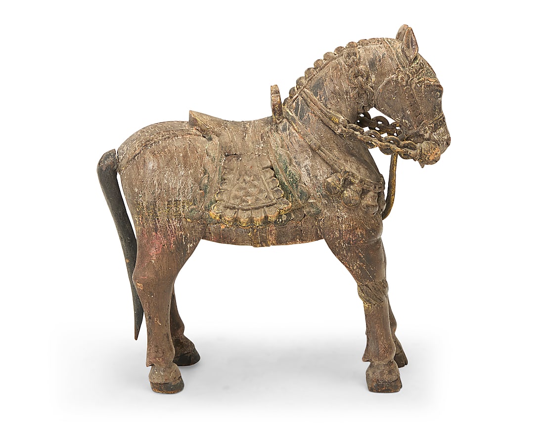 A Chinese Tang dynasty style carved wood horse: A Chinese Tang dynasty style carved wood horse 19th/20th century With detailed saddlery and remnants of polychrome Height 26 1/8 in., width 24 1/2 in., depth 12 1/2 in.