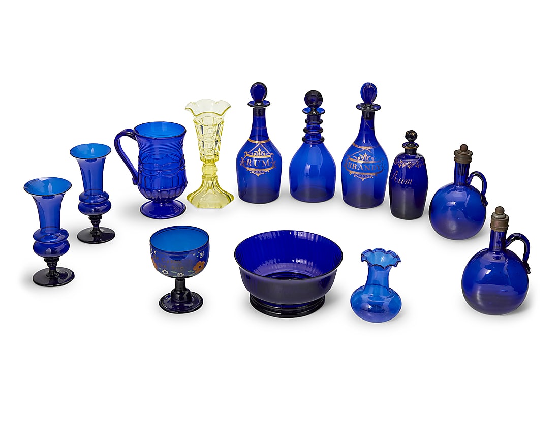 A collection of Bristol blue and other glass table items: A collection of Bristol blue and other glass table items Late 18th-20th century Comprising various bowls, vases, decanters, and cruets, together with a yellow molded glass vase 13 pieces Tallest heigh