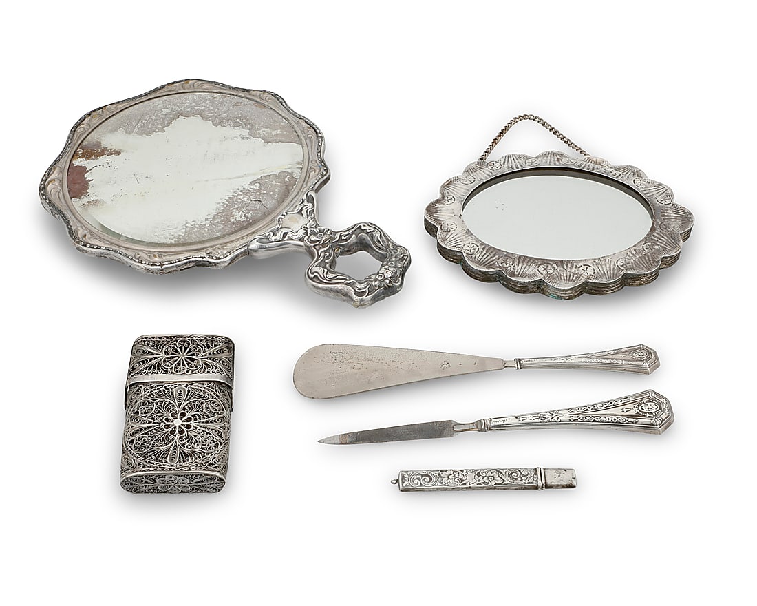 A group of sterling silver and silver plated table items: A group of sterling silver and silver plated table items Late 19th/early 20th century Comprising sterling silver: a filigree business card holder, pencil case, shoehorn, and letter opener; silver-plat