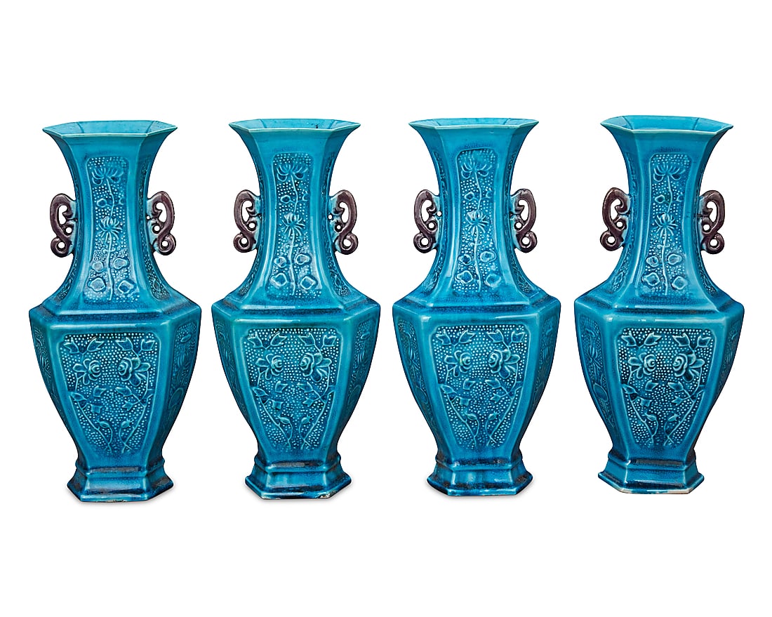 A set of four Chinese turquoise glazed pottery archaistic vases: A set of four Chinese turquoise glazed pottery archaistic vases 20th century Each stamped to underside: MADE IN CHINA Decorated with floral motifs in low relief 4 pieces Height of each 9 3/4 in.,
