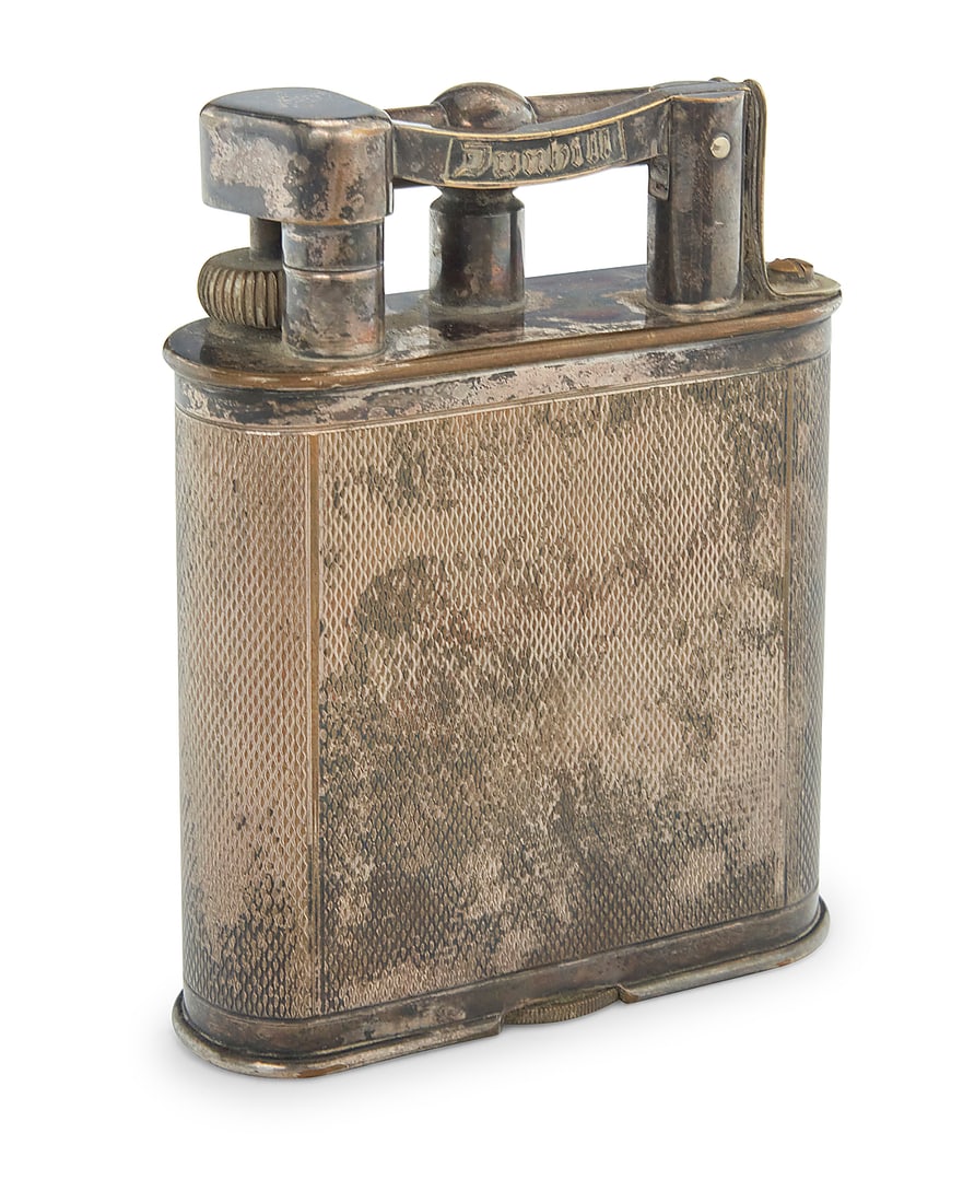 A Dunhill silver plated table lighter: A Dunhill silver plated table lighter Early 20th century Marked for maker and: MADE IN ENGLAND Height 4 1/4 in., width 3 1/4 in., depth 1 1/8 in.