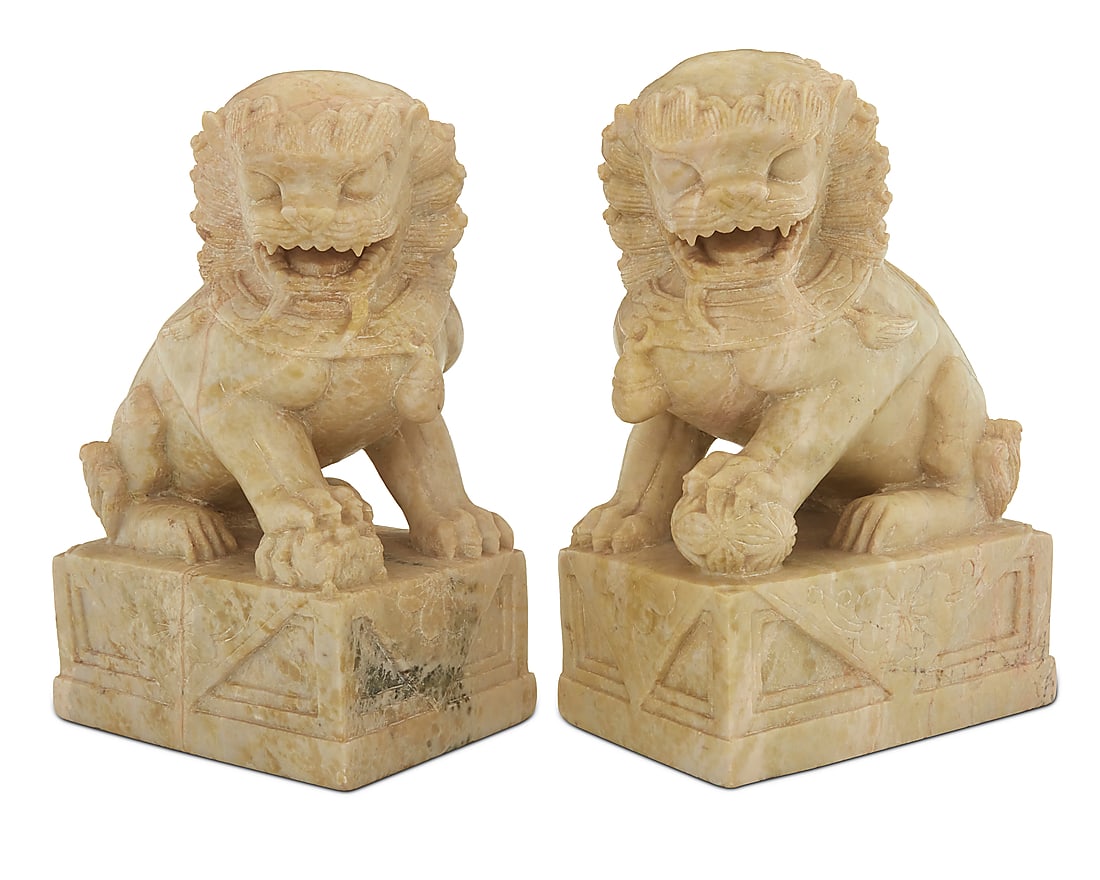 A pair of Chinese carved soapstone guardian lions: A pair of Chinese carved soapstone guardian lions 20th century Each unmarked 2 pieces Height of each 7 1/4 in., width 5 in., depth 3 3/8 in.