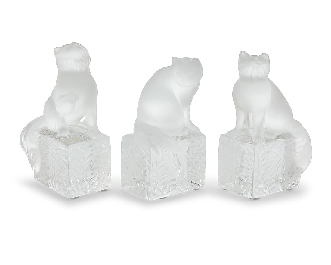 Three Lalique glass cat paperweights: Three Lalique glass cat paperweights Late 20th/early 21st century Each etched to underside: Lalique ® France; one with model number to factory label: 11679 3 pieces Tallest height 5 1/2 in., width 3