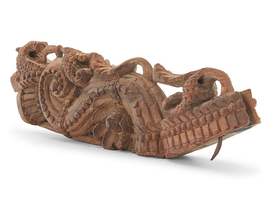 An Asian carved wood architectural element: An Asian carved wood architectural element Possibly Indian, 19th/20th century The S-curve corbel carved with scrolling foliage Height 23 1/2 in., width 7 1/4 in., depth 3 in.