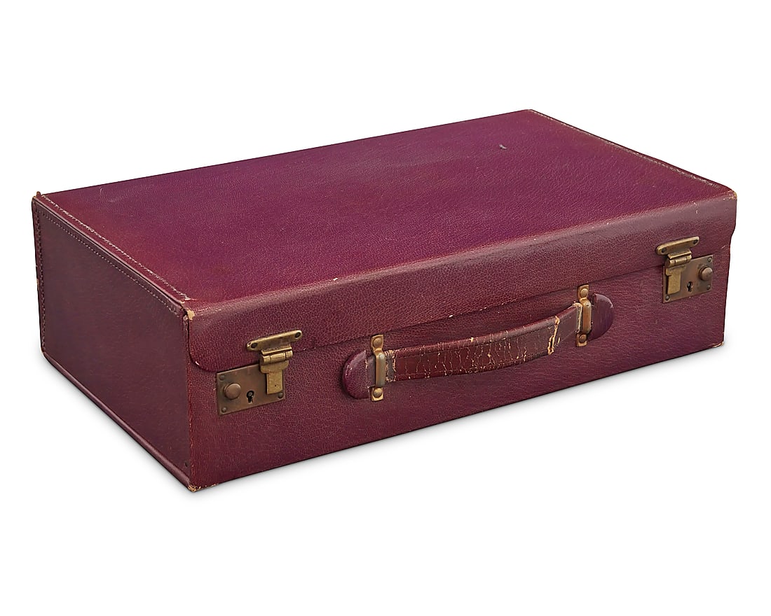 An English cased sterling mounted vanity set from actress Beverly Roberts (1914-2009): An English cased sterling mounted vanity set from actress Beverly Roberts (1914-2009) Circa 1930 The smooth purple leather travelling case holding a fitted vanity set including six glass bottles and