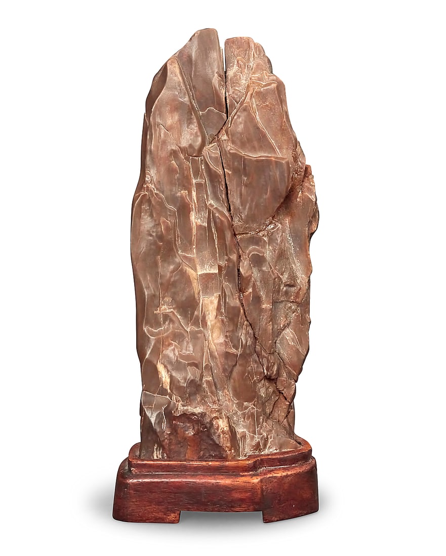 A Chinese style scholar stone: A Chinese style scholar stone 20th century Raised on a wood base Overall height 9 3/4 in., width 4 1/4 in., depth 3 in.