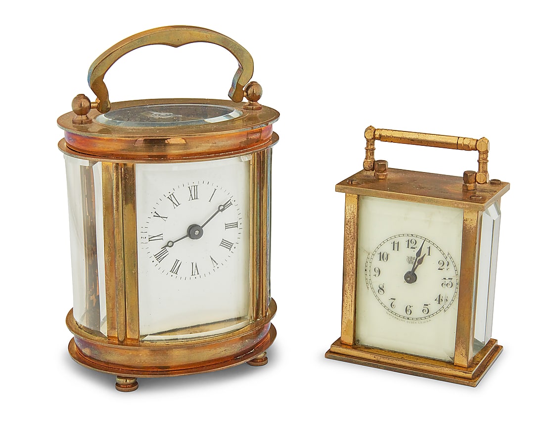 Two brass carriage clocks: Two brass carriage clocks Early 20th century One marked: Waterbury Clock Co. / U.S.A Each glazed case with handle and enameled metal dial, comprising one diminutive Waterbury Clock Co. bearing Arabic 