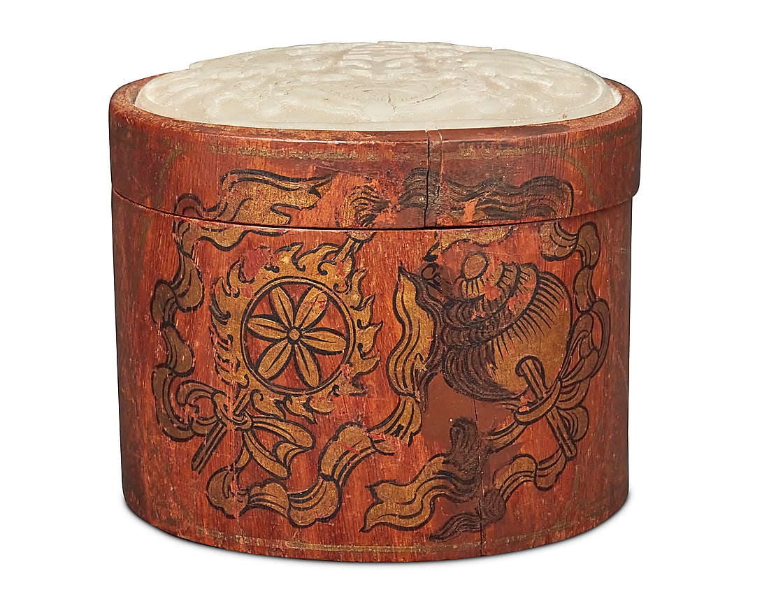 A Chinese carved hardstone plaque mounted as a box: A Chinese carved hardstone plaque mounted as a box Qing Dynasty (1644-1912) The stone lid carved with an urn, fish, and text, later mounted to a carved wood box gilt-painted with floral motifs and wan