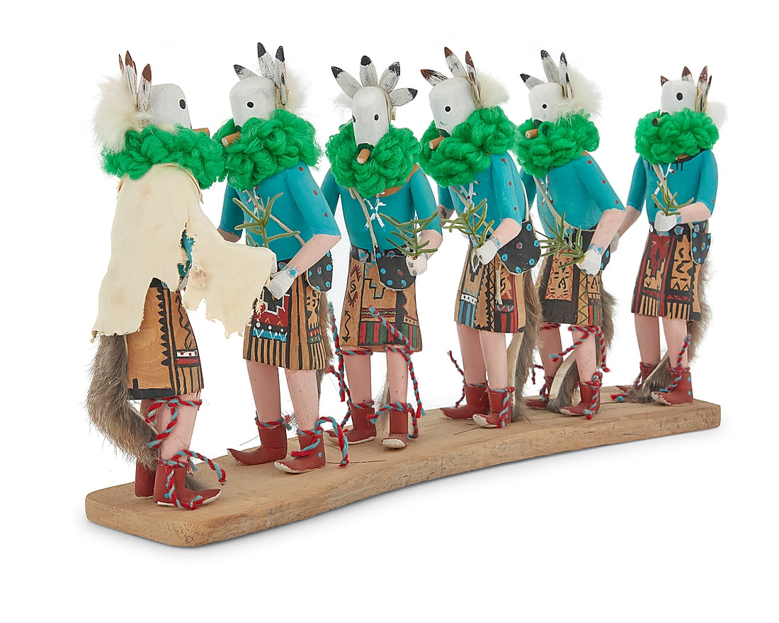 Nancy Kee (20th century, Dine [Navajo]), A carved Yei be chai procession: Nancy Kee (20th century, Dine [Navajo]) A Dine (Navajo) Yei Bi Chei procession Depicting five figures and a talking god, in carved polychromed wood with yarn and fur accents, all mounted to a wood