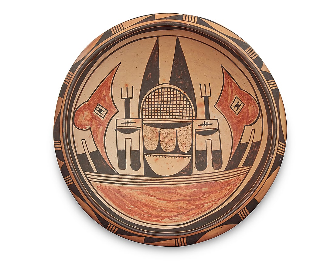 A Hopi polychrome yellowware pottery low bowl: A Hopi polychrome yellowware pottery low bowl Mid-20th century Possibly Nampeyo family made, with red and black figural designs to interior on yellow ground, with banded geometric motifs to shoulder