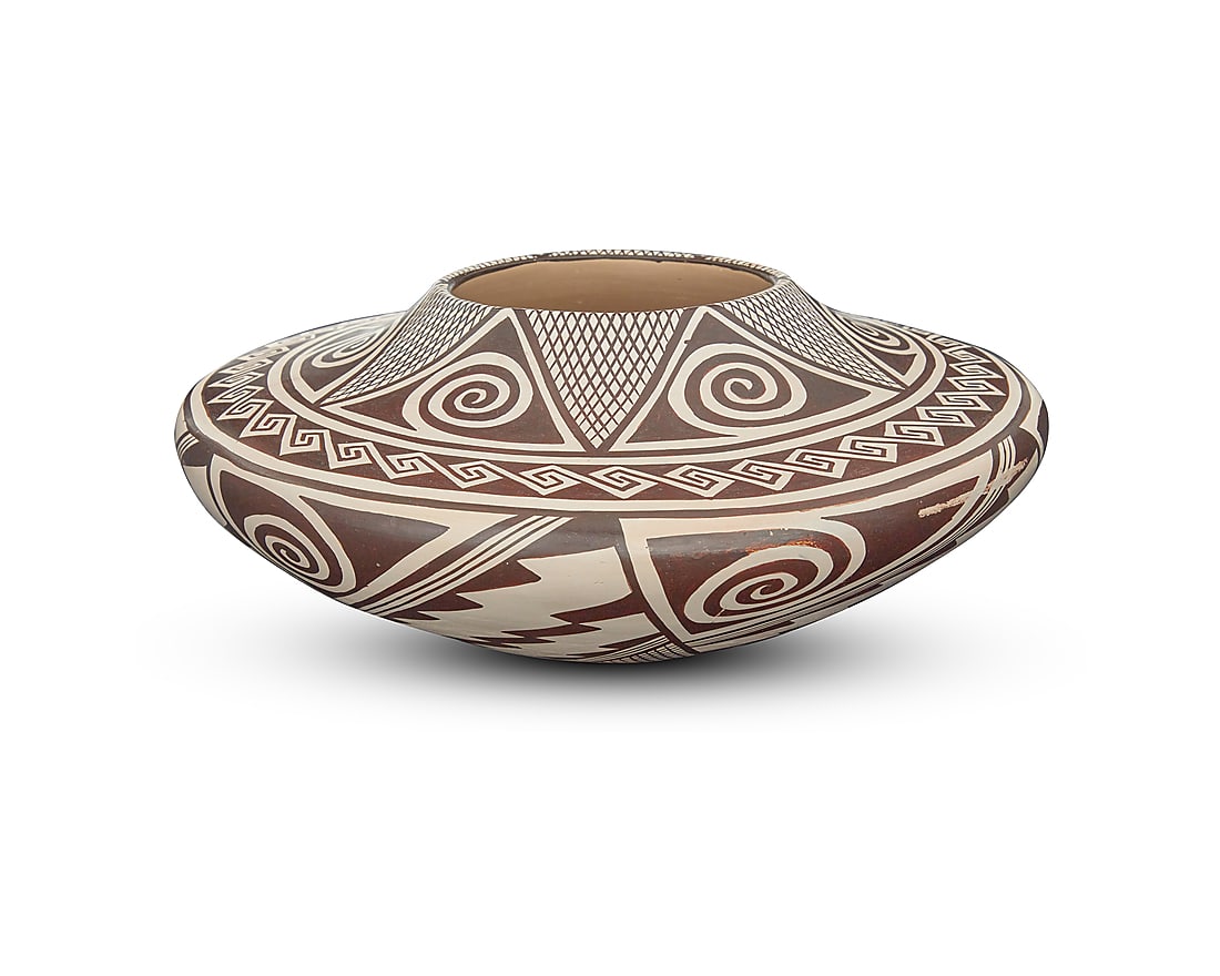 Helen Naha (Feather Woman) (1922-1993, Hopi-Tewa), A black on white low pottery jar, circa 1970: Helen Naha (Feather Woman) (1922-1993, Hopi-Tewa) A black-on-white pottery low jar, circa 1970 With wide shoulder, decorated with black repeating zigzag, crosshatched, and swirling motifs below a