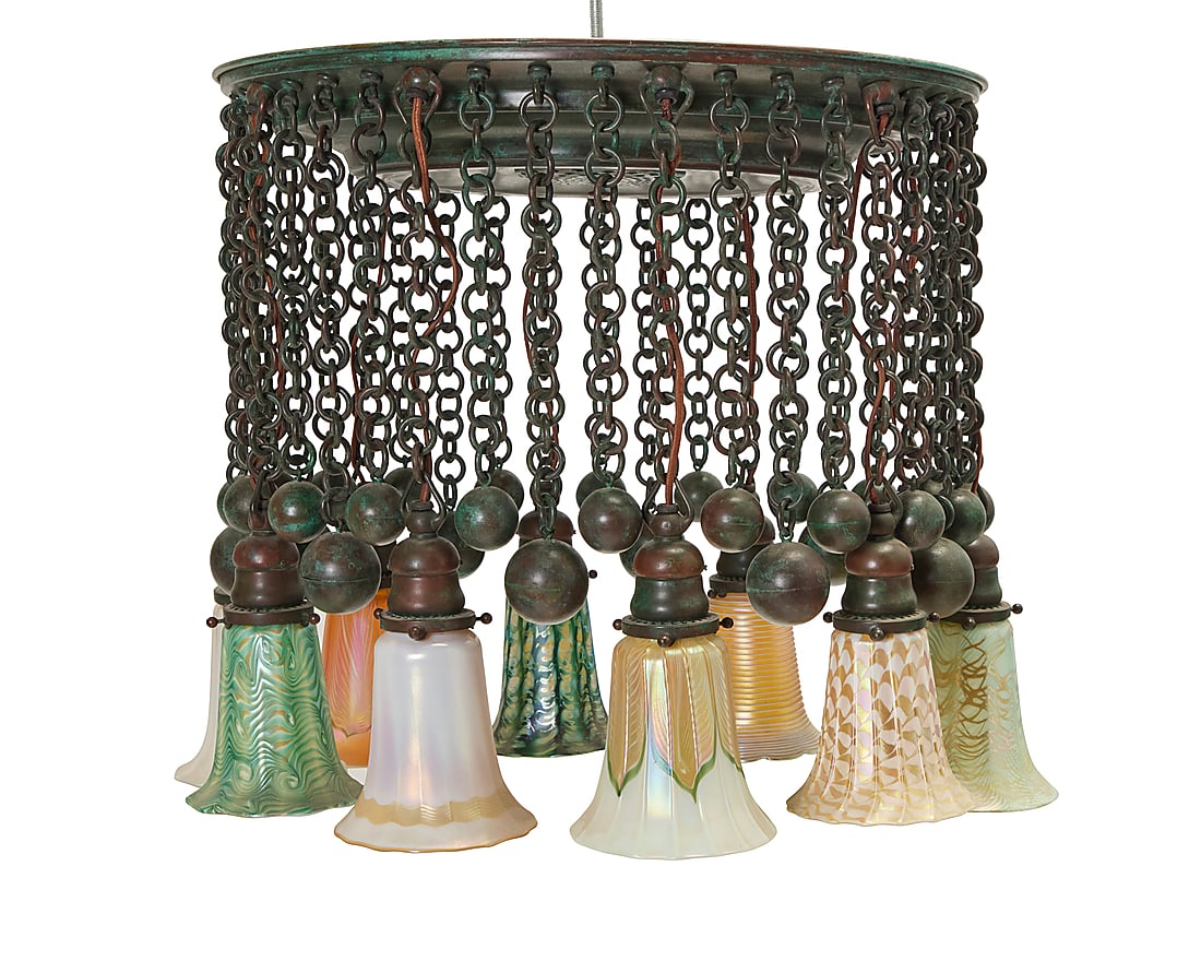 A 'Moorish' chandelier in the style of Tiffany Studios: A 'Moorish' chandelier in the style of Tiffany Studios Early and later 20th century elements Some shades marked: quezal Verdigris patinated bronze issuing ten lights, each with various pulled feather