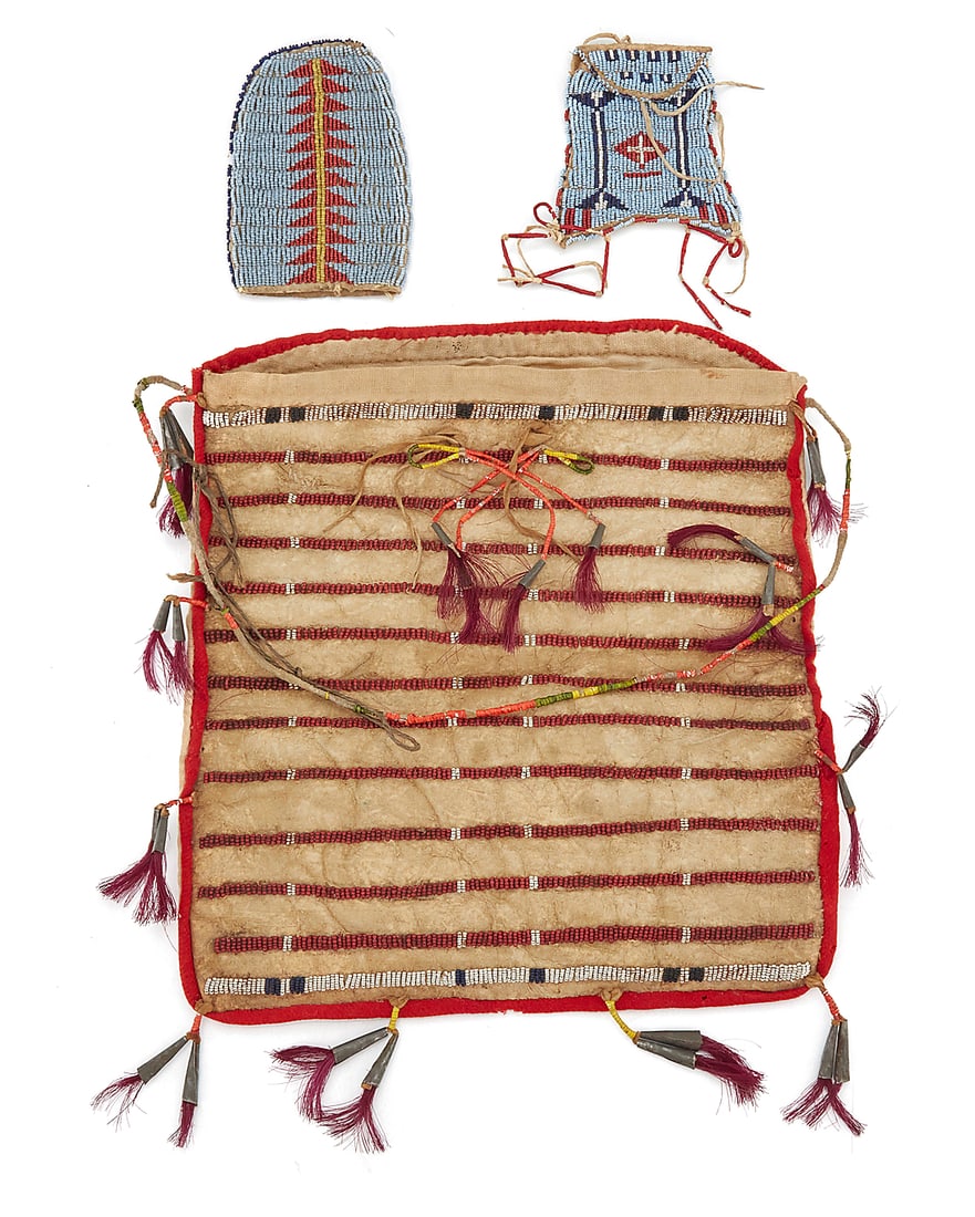 Three Lakota (Sioux) beaded hide pouches: Three Lakota (Sioux) beaded hide pouches Late 19th/early 20th century; Great Plains Comprising a large buffalo hide and cotton fabric pouch with banded polychrome beadwork to front, a quill-wrapped