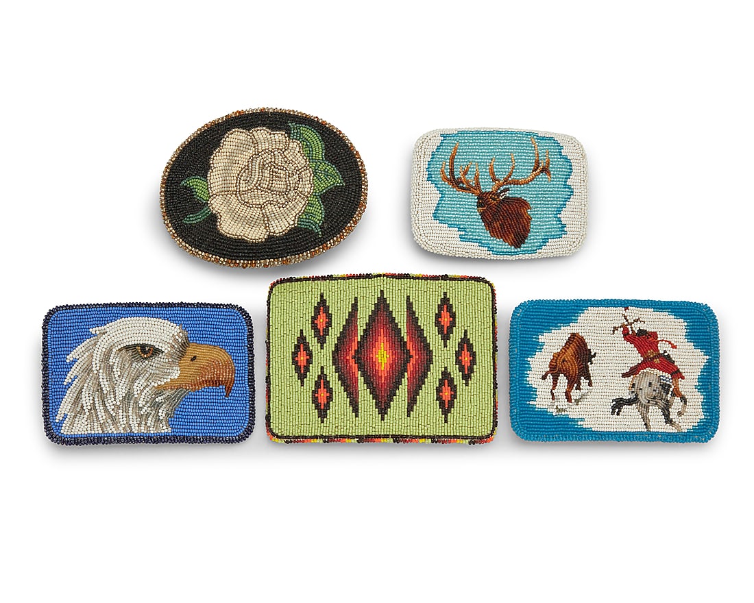 Five contemporary Native American polychrome beaded belt buckles: Five contemporary Native American polychrome beaded belt buckles Late 20th/21st century Comprising five pictorial buckles featuring various motifs including an eagle head on a blue ground, a stag on