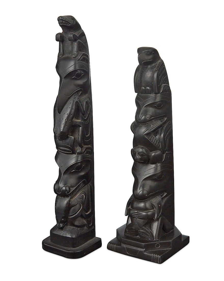 Two carved model totem poles: Two carved model totem poles Early 20th & late 20th century Comprising a Haida carved argillite totem pole featuring an eagle above two figures eating fish and a seal, one likely a bear, and one an