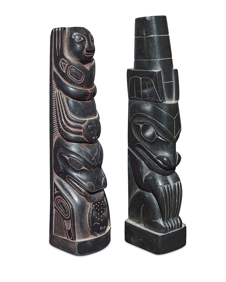 Two carved model totem poles: Two carved model totem poles Mid-20th century; Pacific Northwest Comprising a Haida argillite carving with a single bear figure with narrow claws, and a Northwest Coast-style likely resin carving with