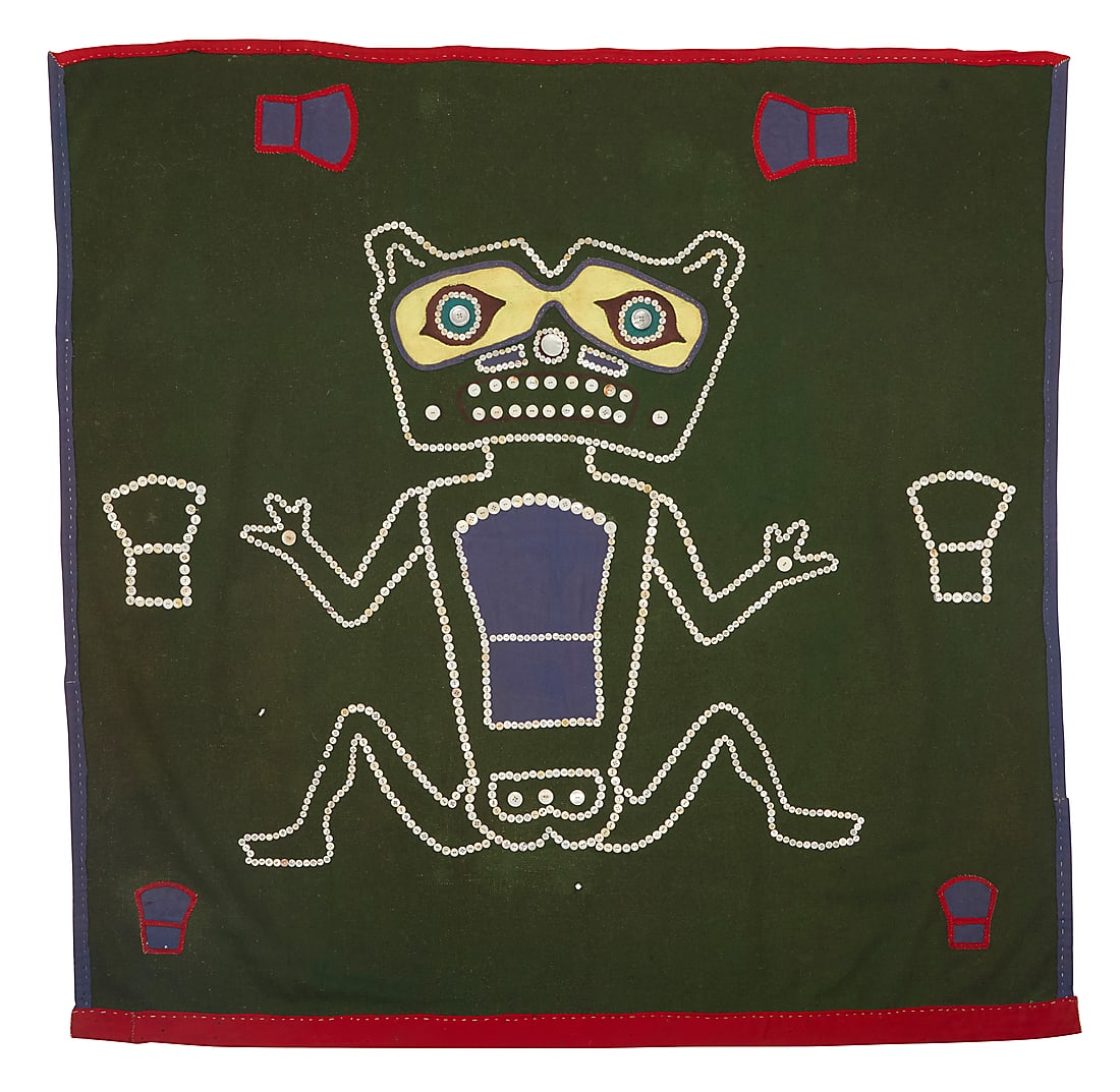 A Northwest Coast button blanket: A Northwest Coast button blanket 20th century Featuring a large central stylized grizzly bear figure with seven shield-shaped 'Copper' motifs, most outlines worked in mother-of-pearl buttons, the