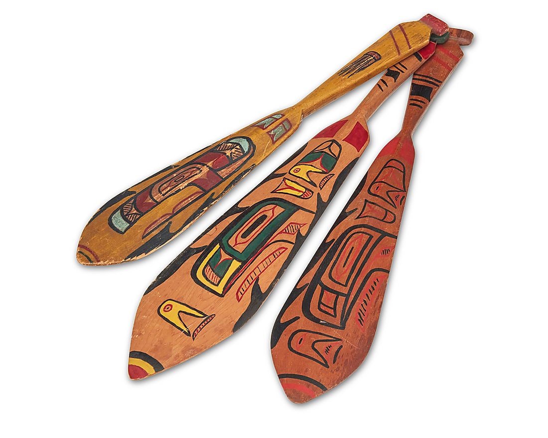 Three Salish polychrome painted paddles: Three Salish polychrome painted paddles Mid-20th century; Pacific Northwest The oar-shaped carved wood women's dance paddles each with painted motifs to one side and to handle Largest 20 x 3 3/4 in.;