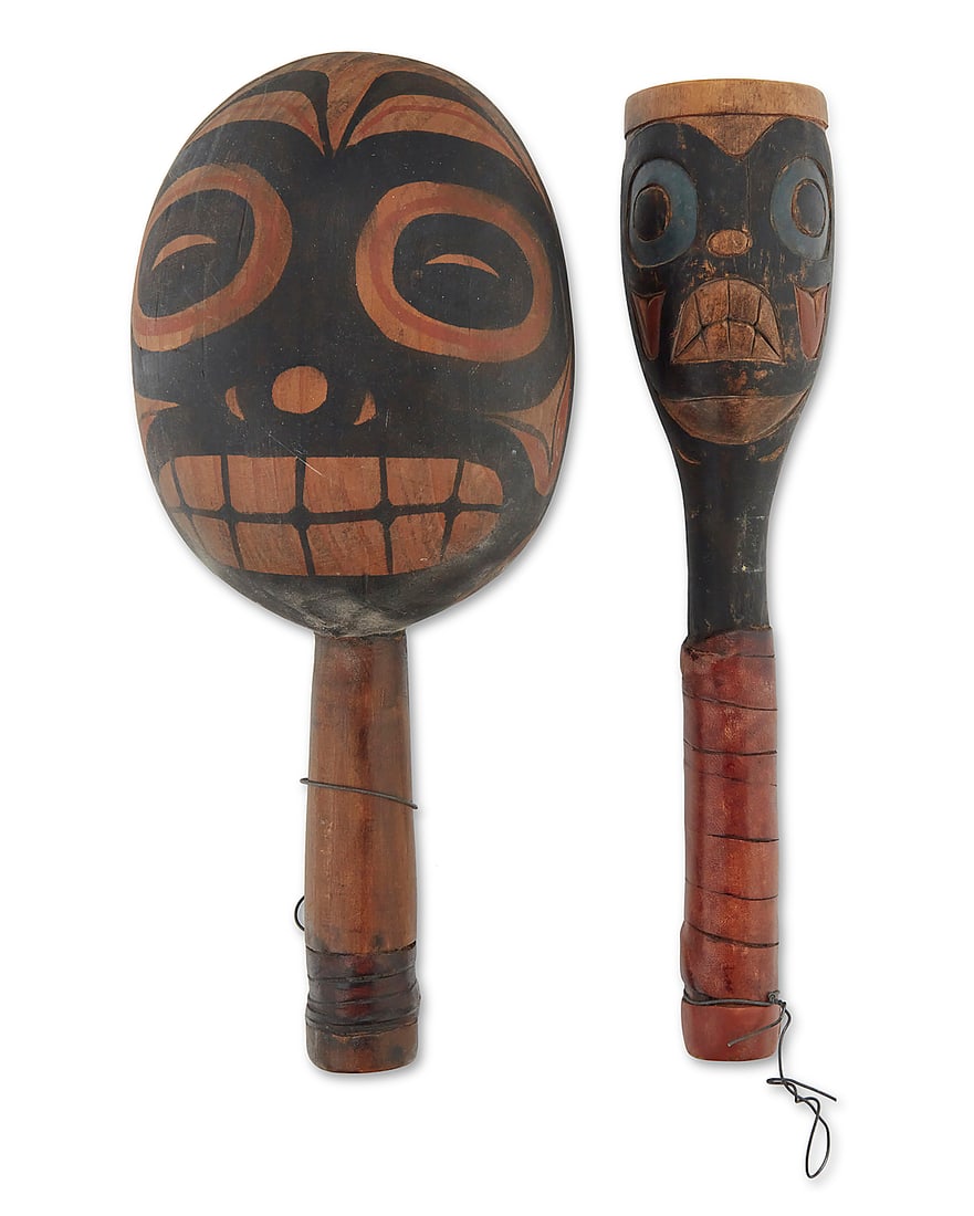 Two Northwest Coast polychrome-painted cedar rattles: Two Northwest Coast polychrome-painted cedar rattles Second half 20th century Comprising a large oval two-sided rattle with painted stylized facial motifs and a small two-sided rattle with painted