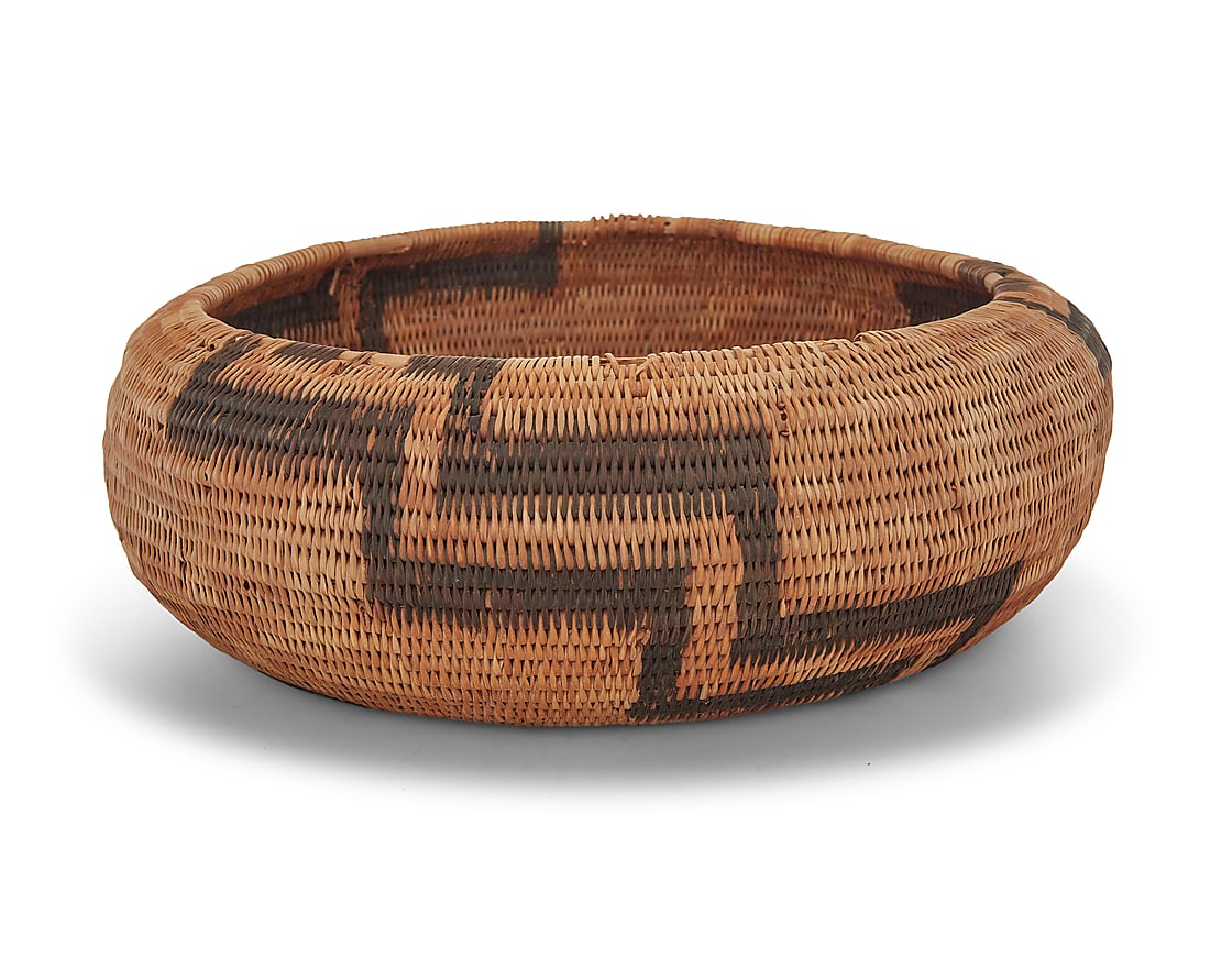 A Pomo basketry bowl: A Pomo basketry bowl Attributed to Laura Fish Somersal (1892-1990, Pomo-Wappo), circa 1986 The large coiled low bowl with three radiating stepped zigzag motifs issuing from center to rim Height 3 in.,
