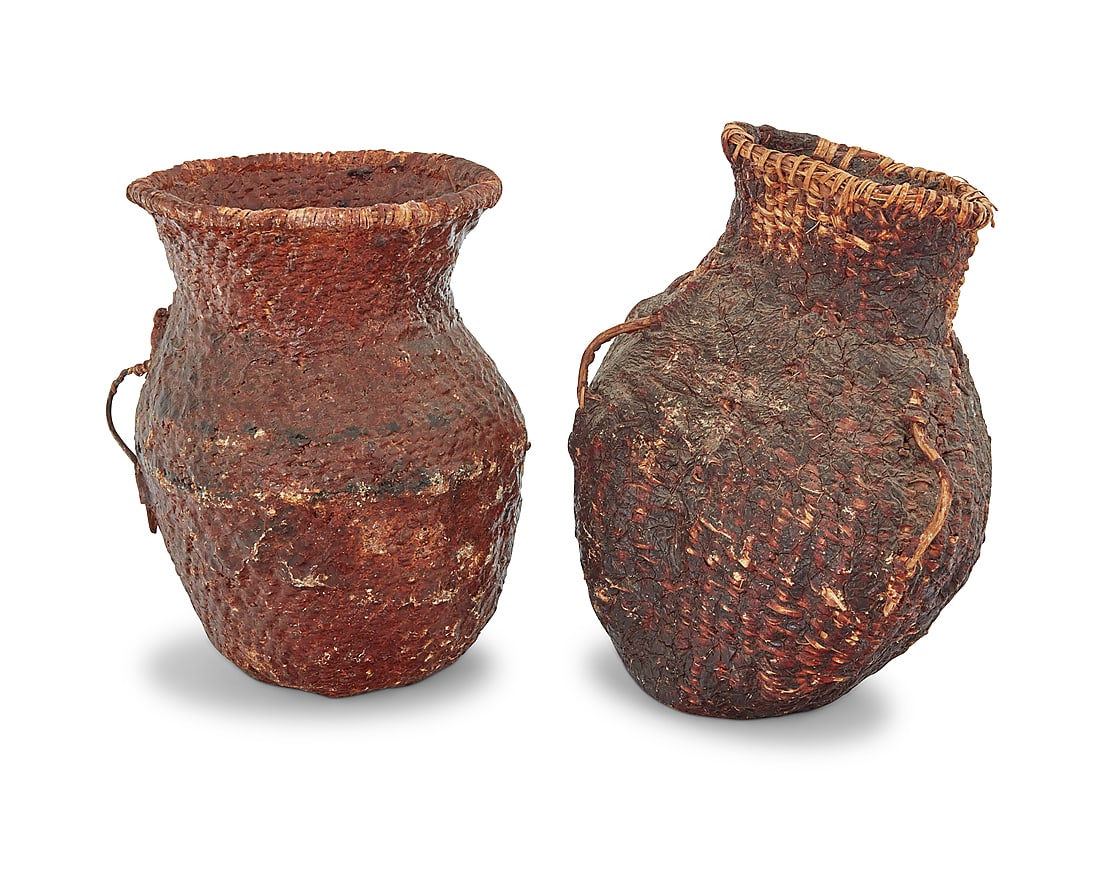 Two Apache pitch-covered basketry vessels: Two Apache pitch-covered basketry vessels Late 19th/early 20th century; Southeast United States Comprising two coiled basketry jars, each with basketry twig handles, and each coated in pine pitch 2