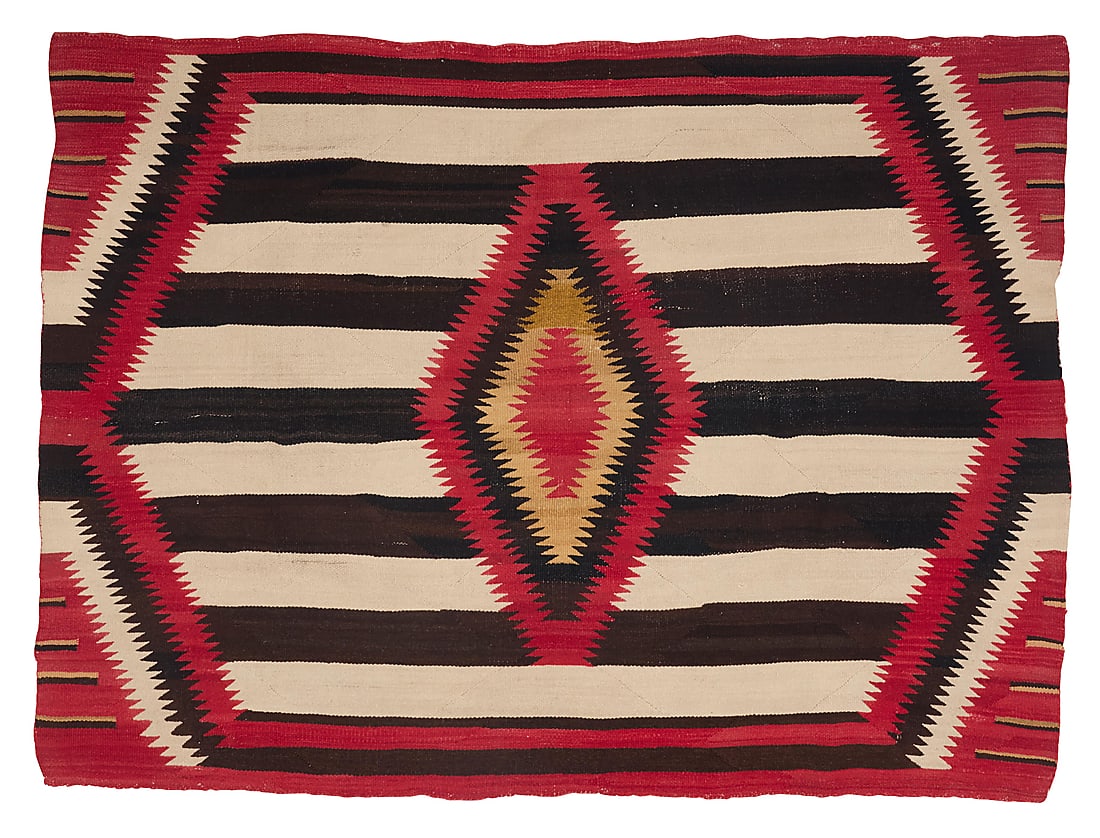 A Dine (Navajo) third phase blanket-style weaving: A Dine (Navajo) third phase blanket-style weaving First half 20th century Woven in red, cream, brown, and ochre wool with contrast banding and a sawtooth diamond to center, with hatched lines to each