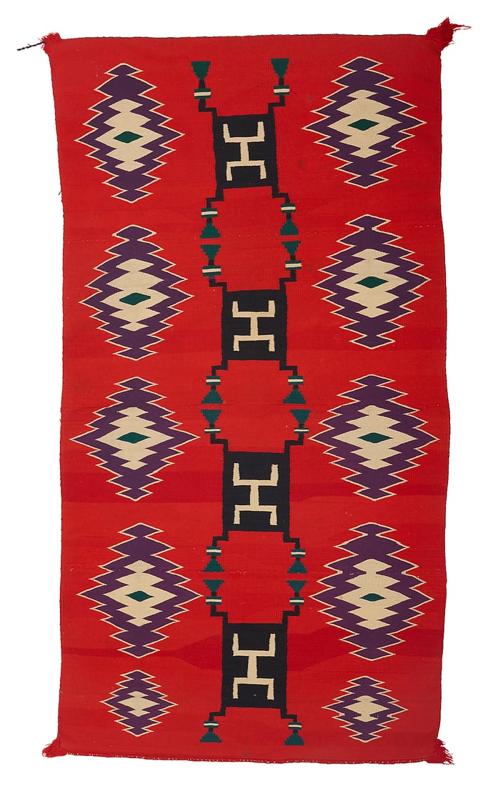 A Dine (Navajo) Germantown textile: A Dine (Navajo) Germantown textile Late 19th century Featuring a central column of four black storm pattern motifs flanked on either side by a column of five sawtooth diamonds, all on a red ground,