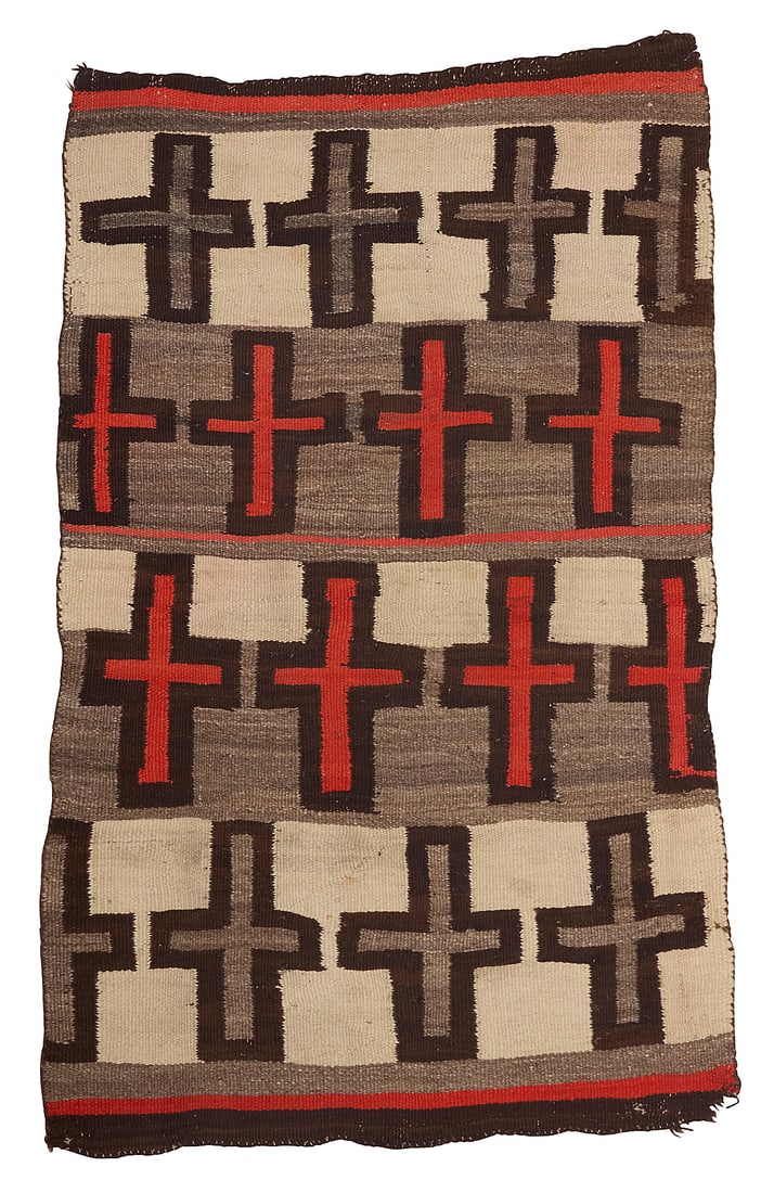 A Dine (Navajo) regional rug: A Dine (Navajo) regional rug First half 20th century Featuring four bands of crosses woven in red, brown, cream and mottled brown wool, with banded ends 5 ft. 6 in. x 3 ft. 6 in. approximately