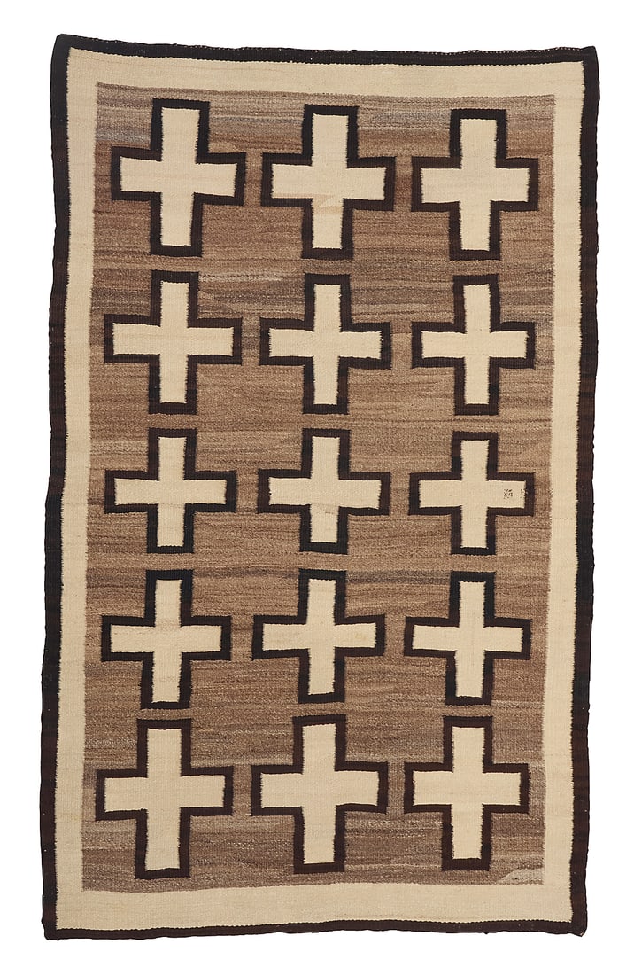 A Dine (Navajo) regional rug: A Dine (Navajo) regional rug Mid-20th century Woven in cream, brown, and mottled grey/brown wool with three columns of floating crosses within a double border 6 ft. 2 in. x 3 ft. 9 in. approximately P
