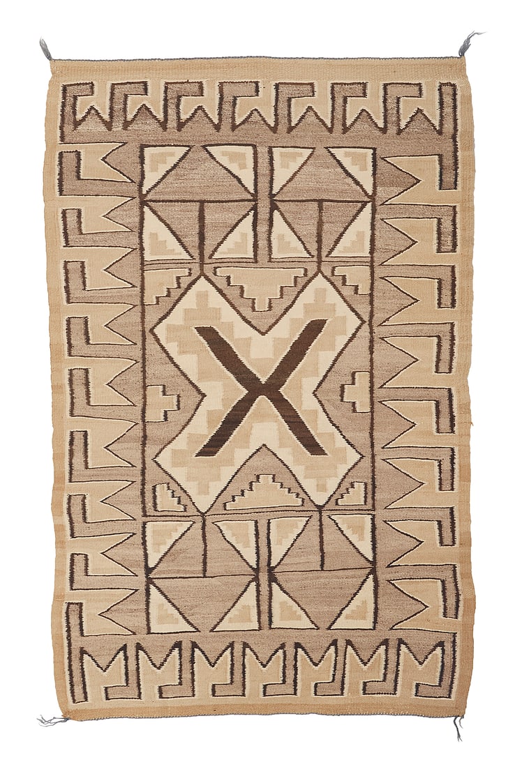 A Dine (Navajo) regional rug: A Dine (Navajo) regional rug Mid-20th century Woven in tan, dark brown, cream, and pale mottled brown wool with a central stepped X-form and further triangle motifs all within a complex hooked border 