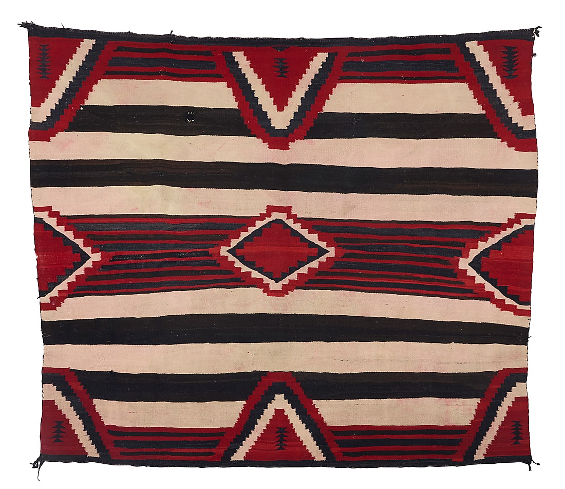 A Dine (Navajo) third phase revival textile: A Dine (Navajo) third phase revival textile Mid-20th century Woven in red, cream, brown, and dark blue wool with contrast and striped banding and stepped diamonds 6 ft. 2 1/2 in. x 5 ft. 3 in. approxi