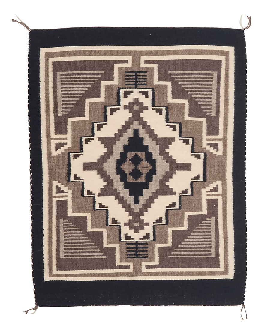 A Dine (Navajo) Two Grey Hills rug: A Dine (Navajo) Two Grey Hills rug Late 20th century Woven in browns, greys, black and cream wool with a central elaborate stepped diamond and stepped motifs to the corners 2 ft. 6 in. x 2 ft. 11 1/4 