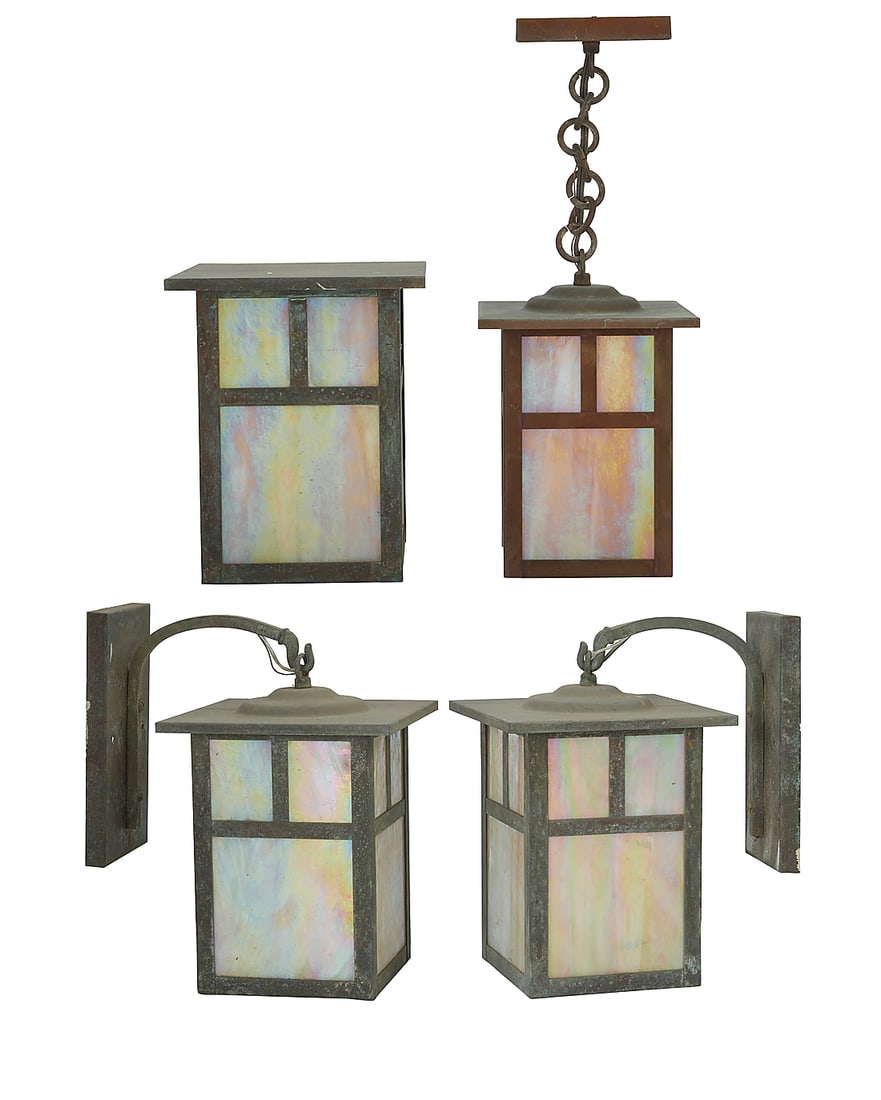 Four Arroyo Craftsman Arts & Crafts-style lanterns: Four Arroyo Craftsman Arts & Crafts-style lanterns Early 21st century The patinated brass cases with iridescent slag glass panels housing a single light, comprising one pair of lanterns hanging from a