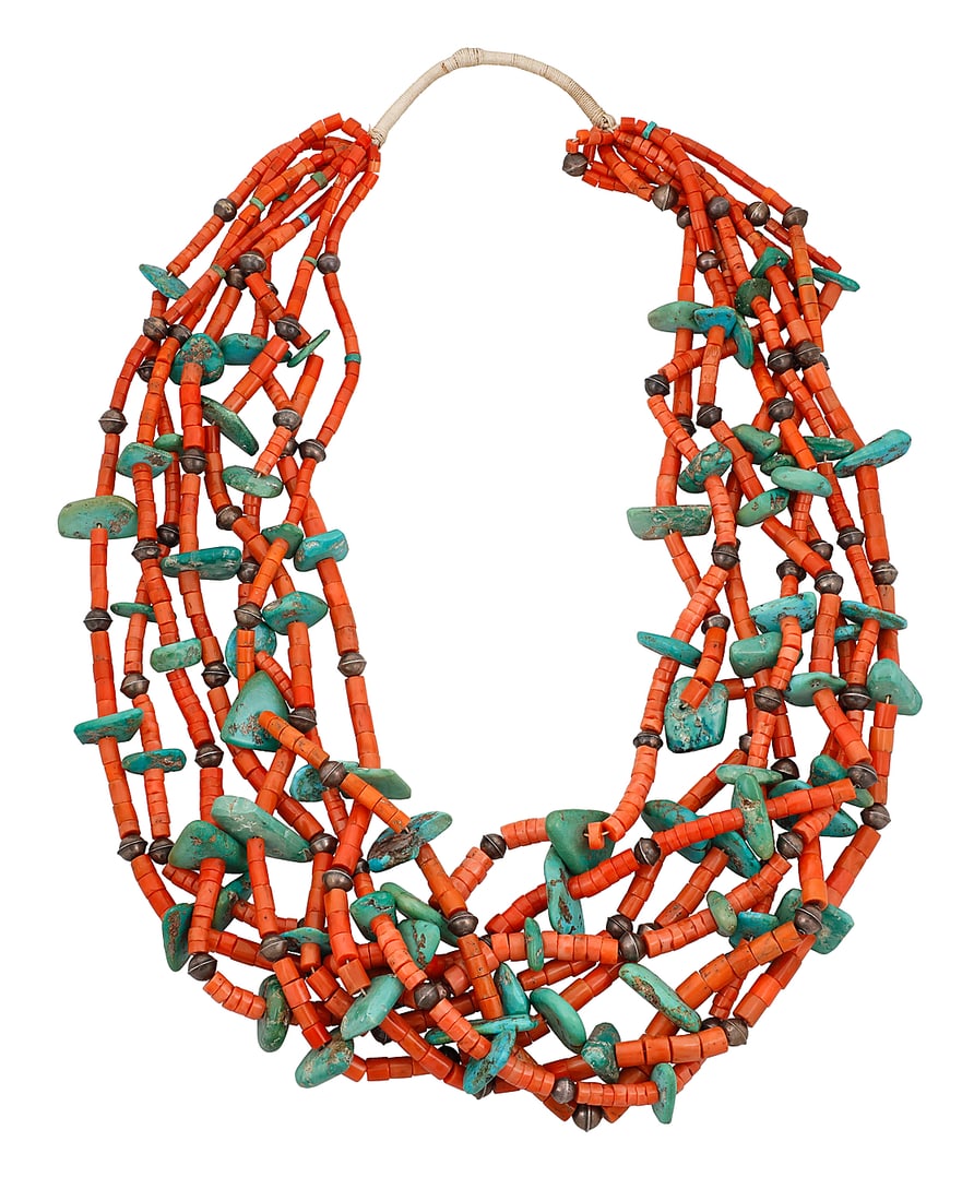 A Pueblo multi-strand necklace: A Pueblo multi-strand necklace Mid-20th century A chunky eight-strand necklace with graduated coral and tab turquoise beads, with silver ball spacers and a traditional wrapped neck cord Unmarked 32 in