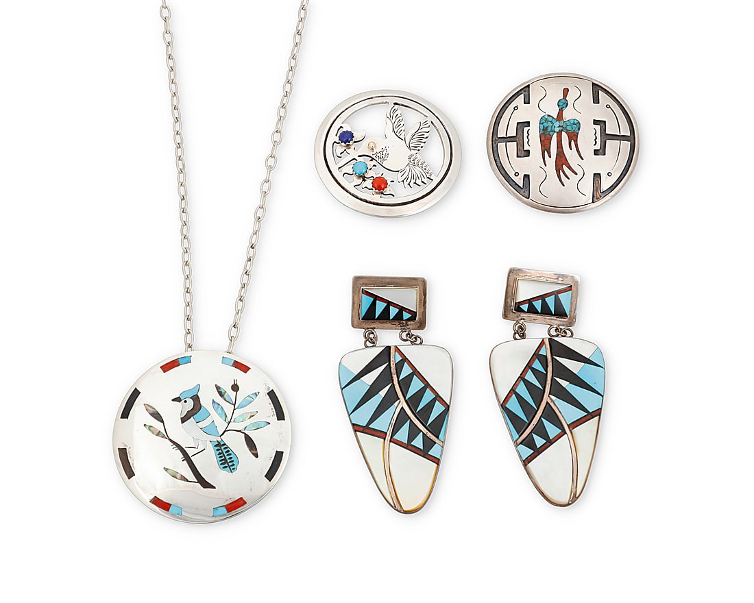 Four Southwest sterling silver and stone inlay jewelry items: Four Southwest sterling silver and stone inlay jewelry items Mid/late 20th century Comprising two round sterling silver pendant/brooches, one with silver overlay and a peyote bird motif in chipped tur