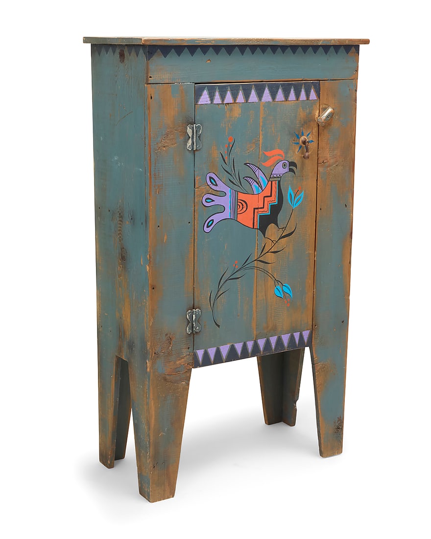 A New Mexican-style painted wood cabinet: A New Mexican-style painted wood cabinet Late 20th/early 21st century The hinged door with Zia Pueblo-style bird, opening to reveal a single shelf Height 48 3/4 in., width 28 1/2 in., depth 13 1/4 in.