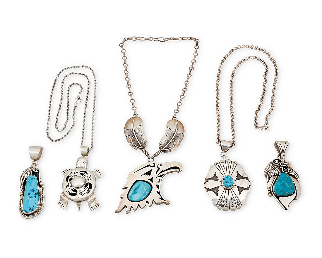 Five Southwest sterling silver pendants: Five Southwest sterling silver pendants Late 20th/21st century Comprising a large shadowbox-style cutout silver eagle head profile pendant necklace with large set turquoise suspended from a silver