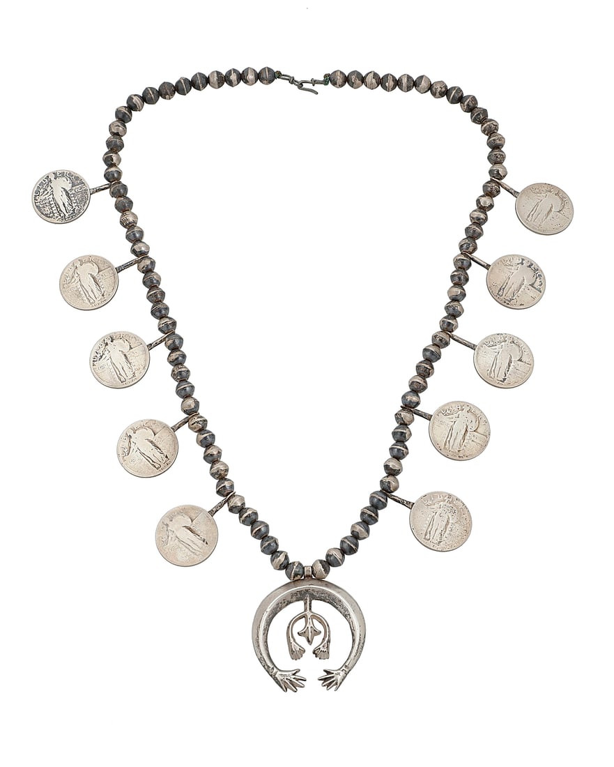 A Southwest sterling silver squash blossom coin necklace: A Southwest sterling silver squash blossom coin necklace Mid-20th century A single strand sterling silver bead necklace with ten 1920s Liberty quarter coin 'blossoms' suspending a cast sterling silver