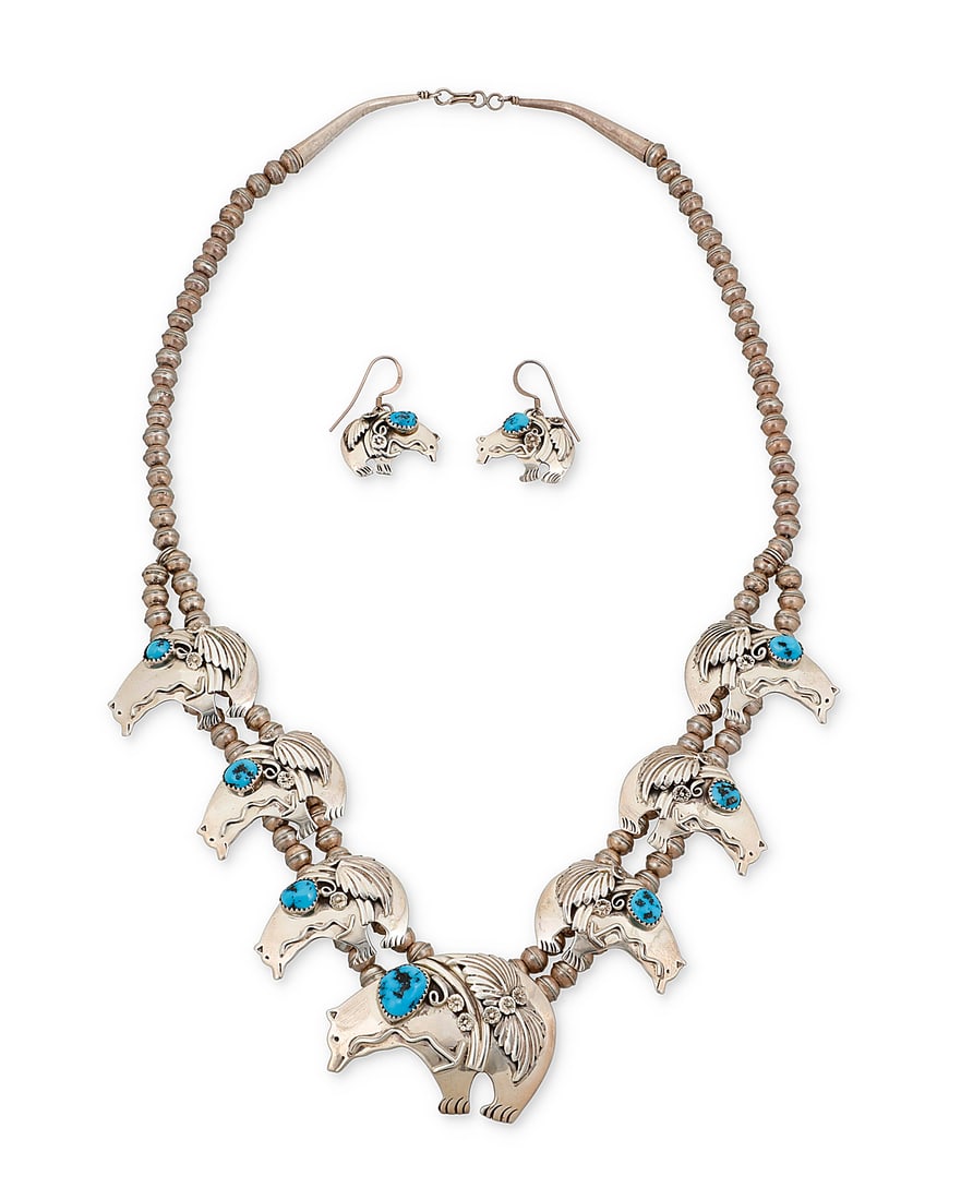 A Southwest sterling silver and turquoise heartline bear necklace demi-parure set: A Southwest sterling silver and turquoise heartline bear necklace demi-parure set Late 20th century A chunky squash blossom-style necklace with six heartline bear 'blossom' plaques and a larger centra