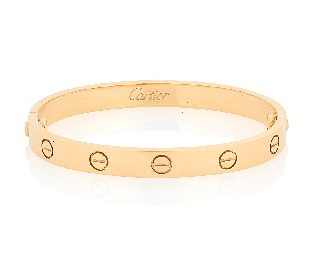 Cartier: An 18K Gold 'Love' Bangle Of a high polish design featuring ten screw motifs and two: Cartier: An 18K Gold 'Love' Bangle Of a high polish design featuring ten screw motifs and two screws, signed Cartier, 16, FW3256 Inner Circumference: 6 in. 31.9 grams gross