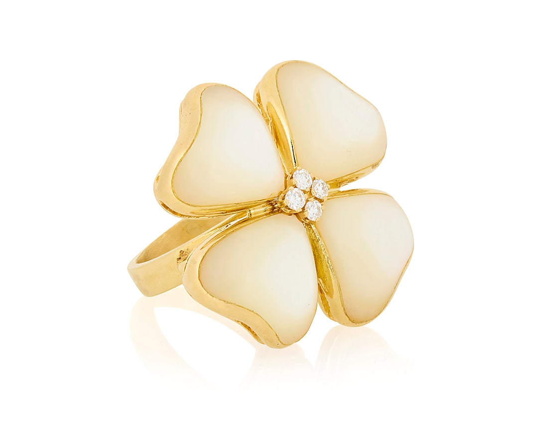Gucci: An 18K Gold and Mother-of-Pearl Ring Of a clover design featuring mother-of-pearl inlay: Gucci: An 18K Gold and Mother-of-Pearl Ring Of a clover design featuring mother-of-pearl inlay centering four round diamonds, signed Gucci, Italy Size: 6 1/2 12.9 grams gross