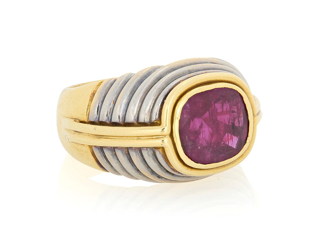 An 18K Bi-Color Gold and Ruby Ring Of a tiered design centering a cushion-cut ruby measuring (1 of 3)