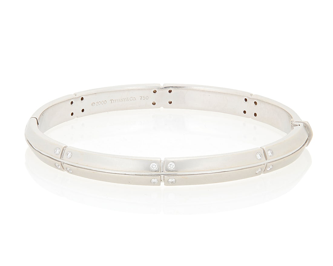 Tiffany: An 18K White Gold and Diamond 'Streameric' Bracelet Of a hinged design featuring satin: Tiffany: An 18K White Gold and Diamond 'Streameric' Bracelet Of a hinged design featuring satin finish segments, accented by twenty-four round diamonds, signed Tiffany & Co., 2000 Inner circumference: