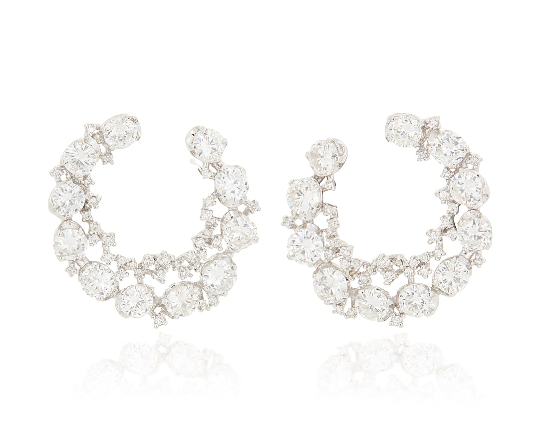 A Pair of 14K White Gold and Diamond Earrings Of an ornate crescent design set with round diamonds: A Pair of 14K White Gold and Diamond Earrings Of an ornate crescent design set with round diamonds weighing approximately 6.75 carats total 2 pieces Measures: 1 x 1 in. 9.2 grams gross